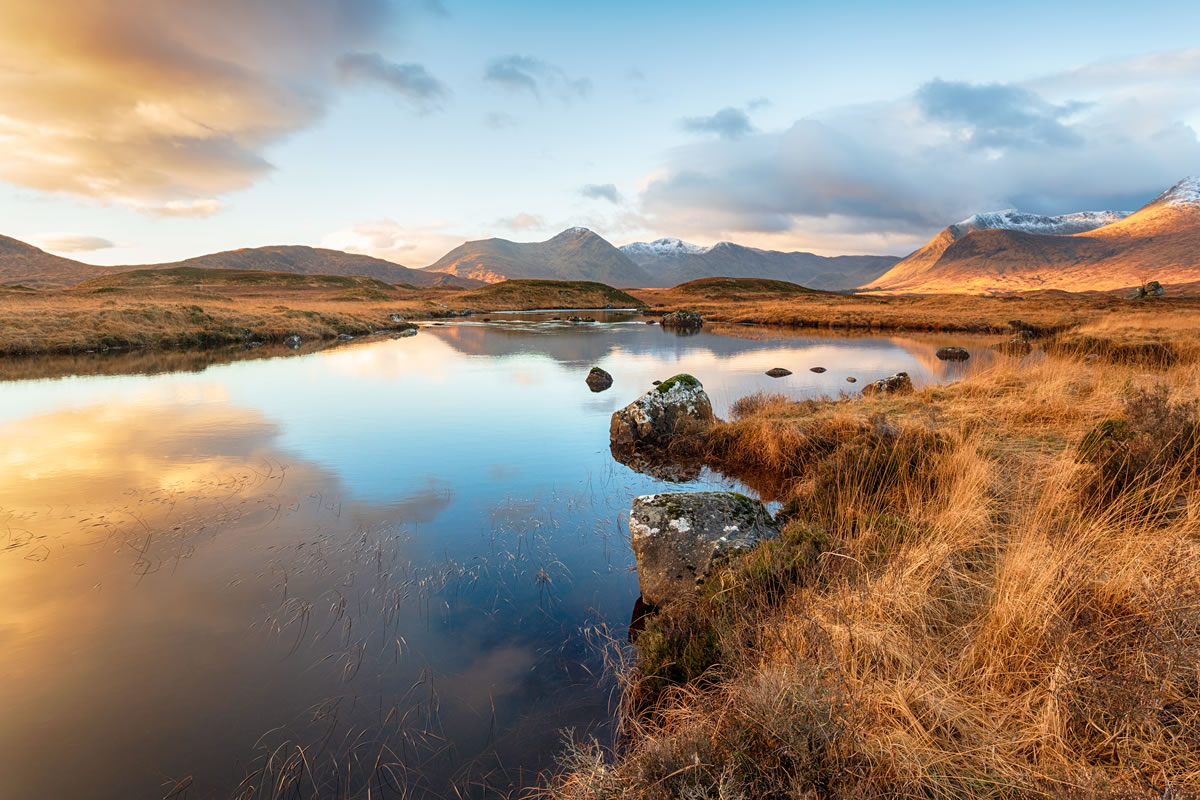 Bespoke Programs Serene Scottish landscape with water and mountains.